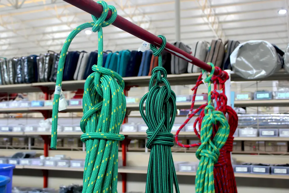 Coils of green and red marine rope suspended in a chandler