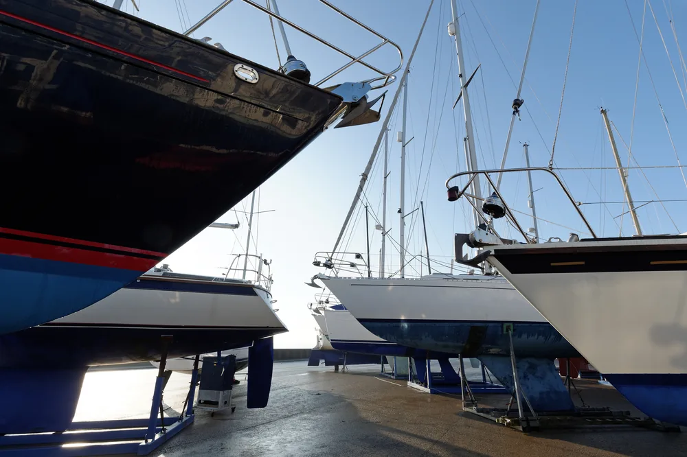 Boats in a working boatyard, some supported on stands